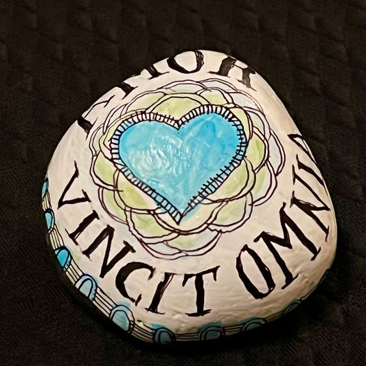 Hand painted stone - "Love Conquers All"